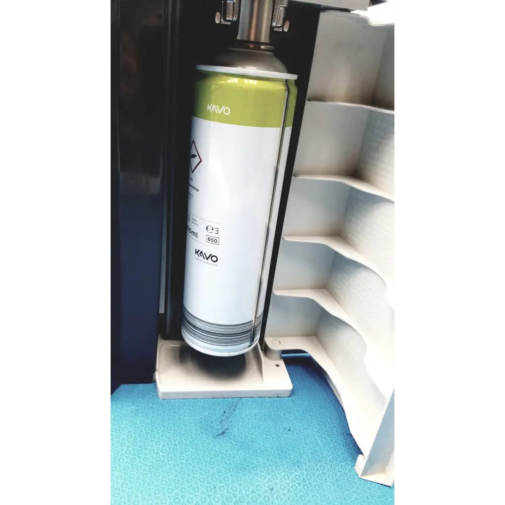 A white and lime green metallic kavo quattrocare plus aerosol can labeled e3 850 for handpiece maintenance
