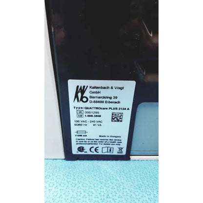 Black dental handpiece with white label showing manufacturer details in kavo quattrocare plus 2124 a maintenance system