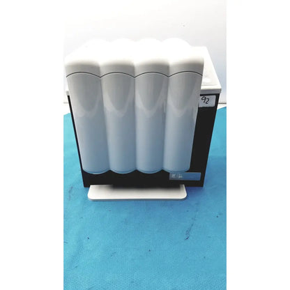 White ceramic water filter cartridge holder with four cylindrical cartridges for kavo quattrocare plus system