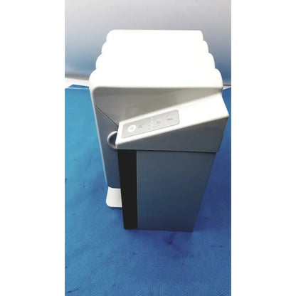 White and gray kavo quattrocare plus 2124 a handpiece maintenance system with sleek modern design and front control panel