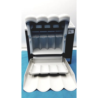 White plastic coin dispenser with scalloped roof and compartments for the kavo quattrocare plus 2124a maintenance system