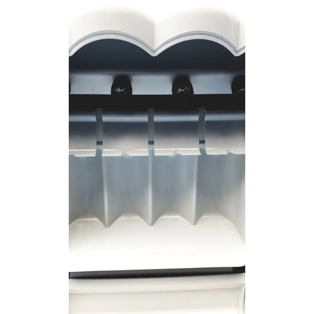 White plastic ice maker with scalloped top and multiple slots for ice cubes in kavo quattrocare plus 2124a system
