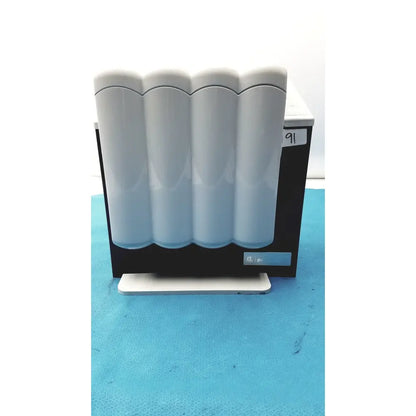 White glossy cylindrical filter cartridges in black and white industrial filtration unit for kavo quattrocare plus 2124a system