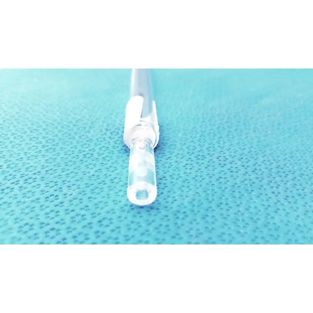 Clear plastic iv catheter with white hub and transparent tubing shown alongside kimax 25ml 10ml glass mohr measuring pipette reusable labware