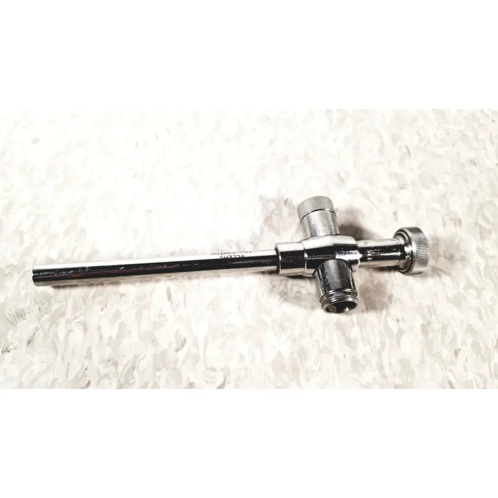 Shiny chrome-plated reusable metal trocar sleeve with long cylindrical shaft and two threaded connectors end