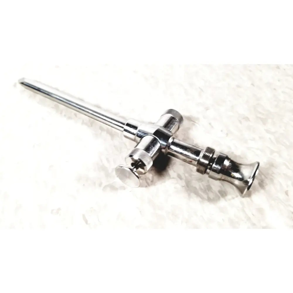 Shiny chrome reusable metal trocar sleeve with long slender shaft and cross-shaped handle featuring threaded sections