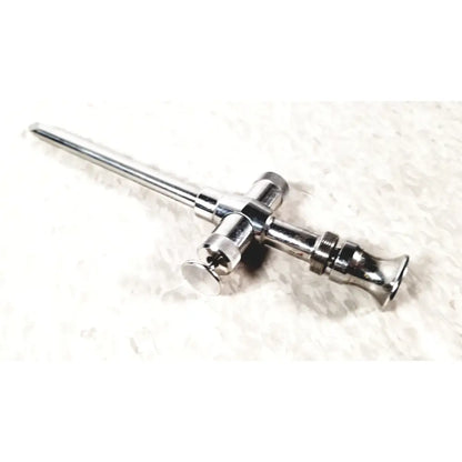 Shiny chrome reusable metal trocar sleeve with long slender shaft and cross-shaped handle featuring threaded sections