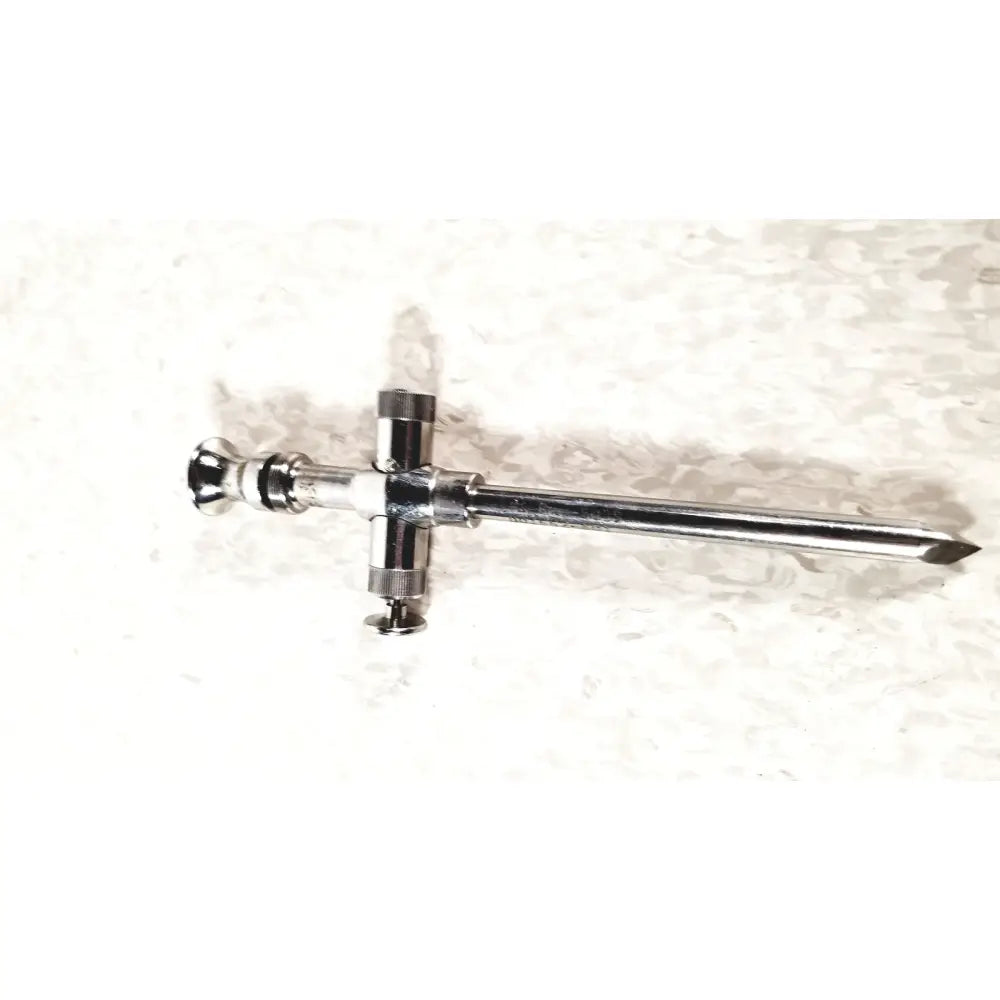 Shiny chrome reusable metal trocar sleeve kli 001662-501 with long slender shaft and cross-shaped handle