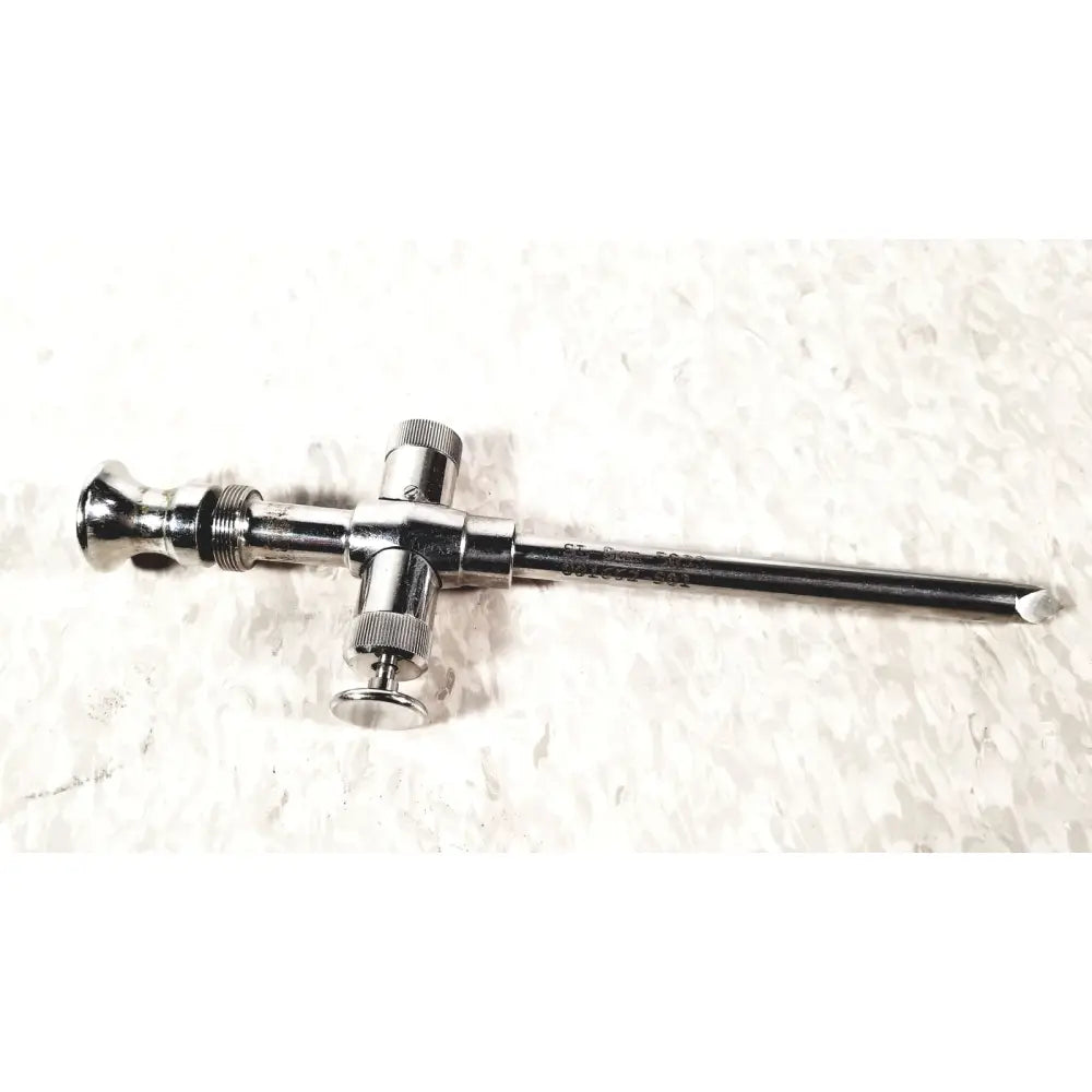 Shiny metallic reusable metal trocar sleeve with cross-shaped handle and threaded components in silver color
