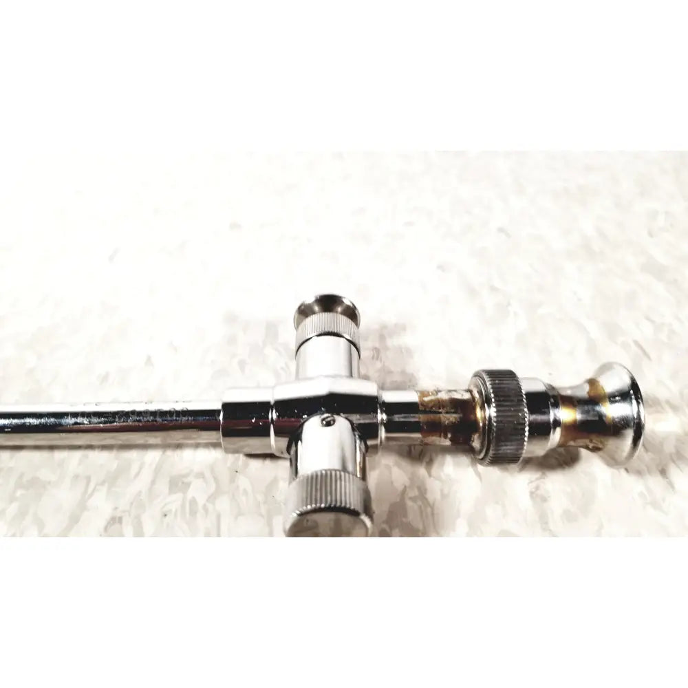 Chrome finished t-shaped valve with threaded connections and tarnished brass section for reusable metal trocar sleeve kl 001662-501