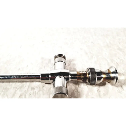 Chrome finished t-shaped valve with threaded connections and tarnished brass section for reusable metal trocar sleeve kl 001662-501