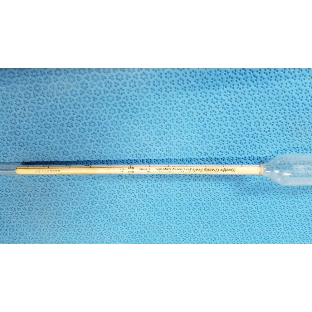 A clear glass specific gravity hydrometer with yellowish gravity hydrometer scale for light liquids temp 60°/60°F