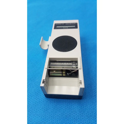 White and black portable radio with circular speaker grille labeled horo 038 from koven wave hadeco moel es-1000spm