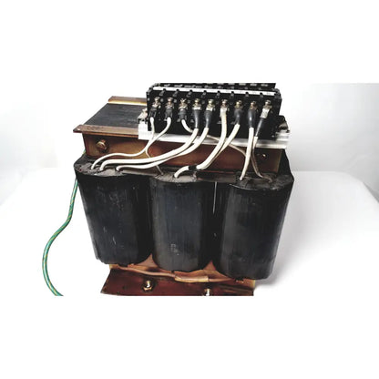 Black cylindrical power transformer by Kowa Sangyo with copper windings and white insulated wires for reuse medical applications