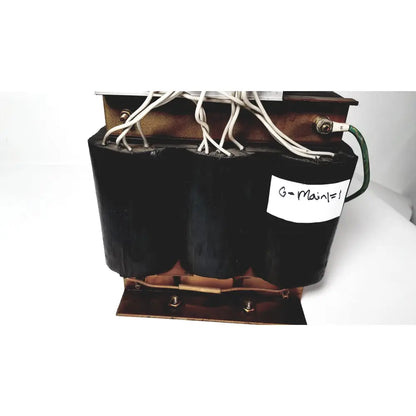 Black cylindrical power transformer by kowa sangyo with copper windings and white wiring labeled g-main=1 for reuse medical
