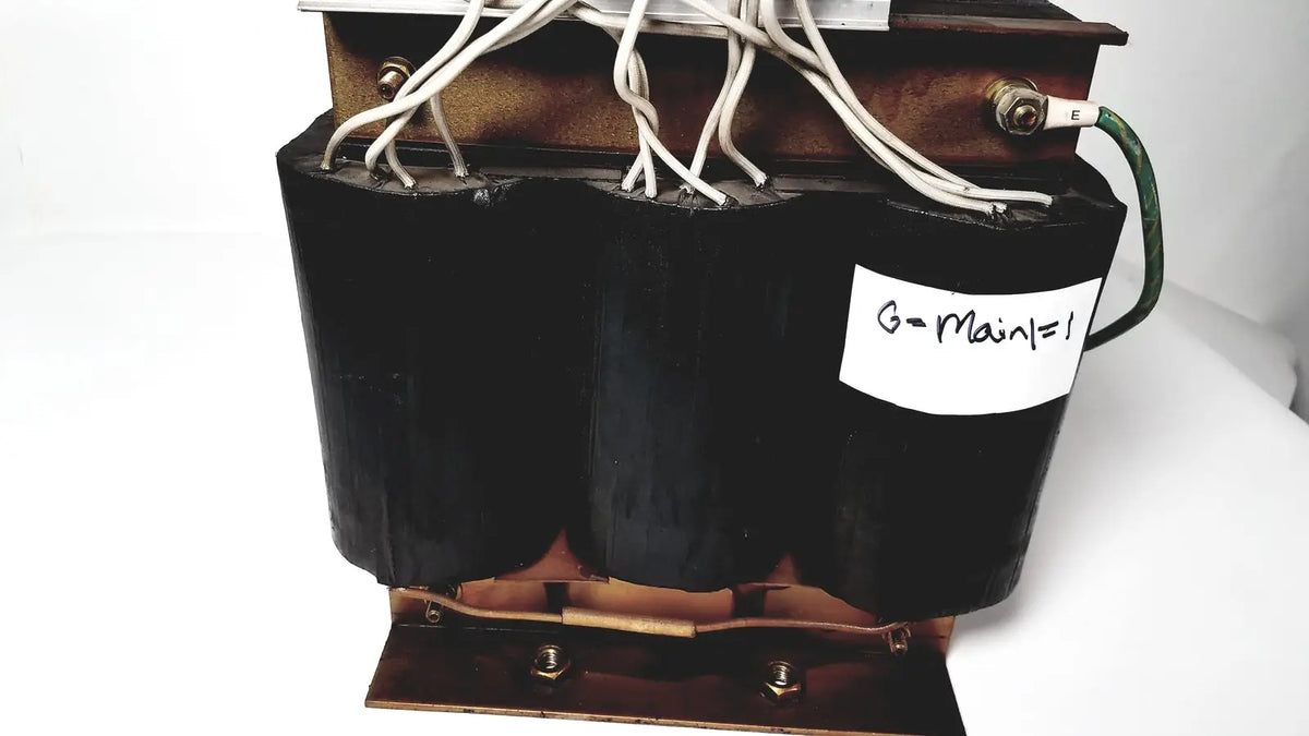 Black cylindrical power transformer by kowa sangyo with copper windings and white wiring labeled g-main=1 for reuse medical