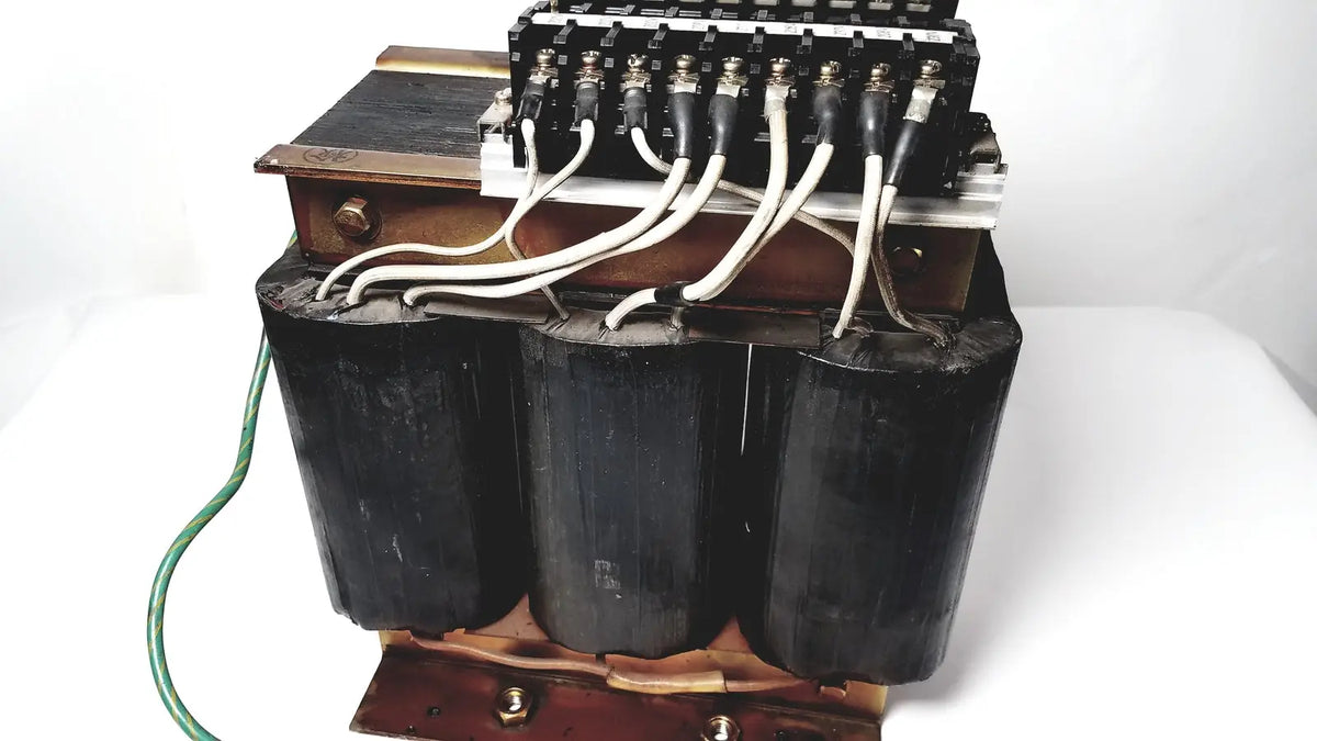 Black cylindrical power transformer by Kowa Sangyo with copper windings and white insulated wires for reuse medical applications