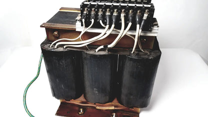 Black cylindrical power transformer by Kowa Sangyo with copper windings and white insulated wires for reuse medical applications