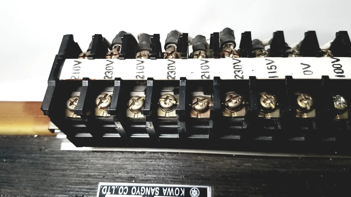 Black plastic terminal block with gold screws and white voltage labels 230v 15v 0v on kowa sangyo power transformer