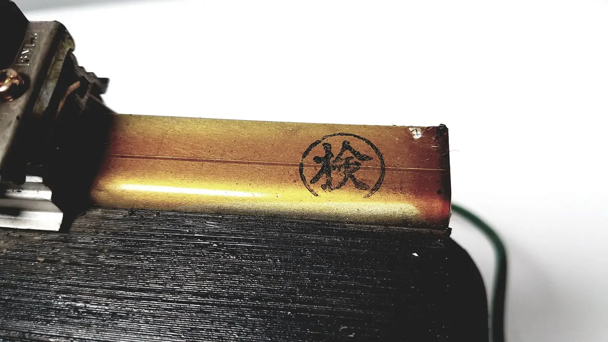 Golden metallic kowa sangyo co ltd transformer with circular stamp featuring chinese character檢 for power transformers reuse medical use