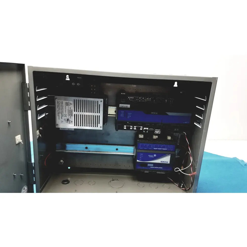 Black industrial control panel housing multiple blue-lit electronic devices with wiring in kryptonite cmt22a access system