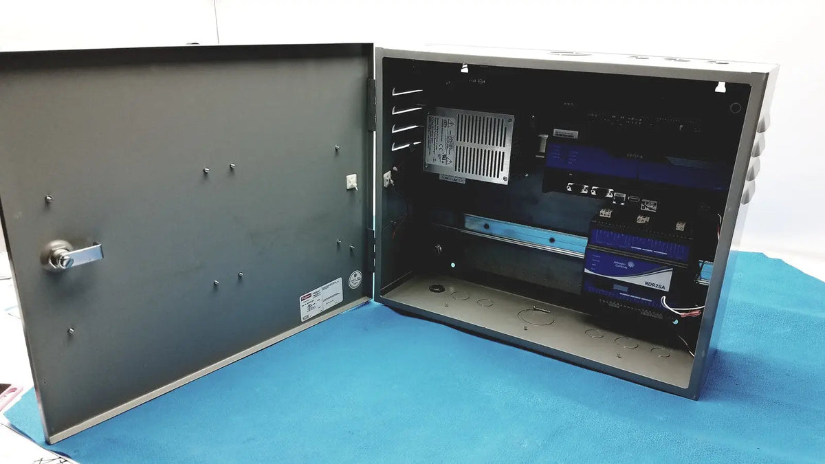 Gray metal electrical enclosure with hinged door and visible internal components for kryptonite cmt22a access control system