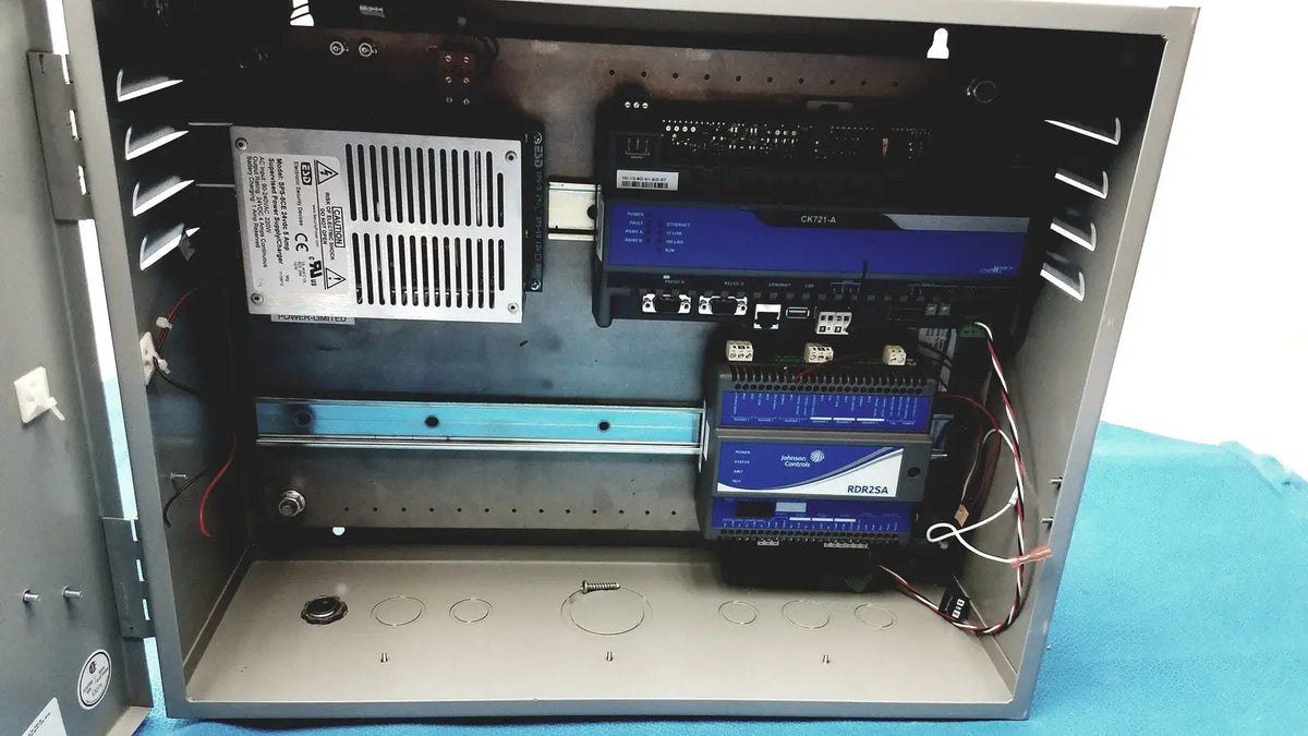 Gray metal industrial control panel housing electronic components including power supply for kryptonite cmt22a access control