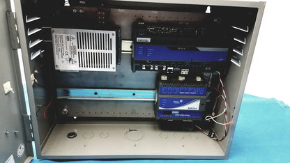 Gray metal industrial control panel housing electronic components including power supply for kryptonite cmt22a access control