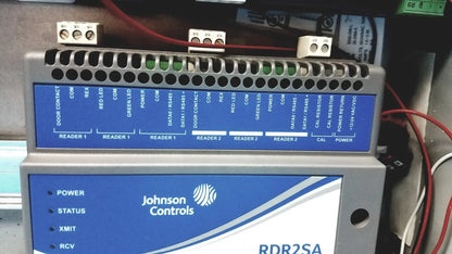 Gray and blue industrial control panel labeled johnson controls rdr2sa with ports and lights for kryptonite cmt22a access control