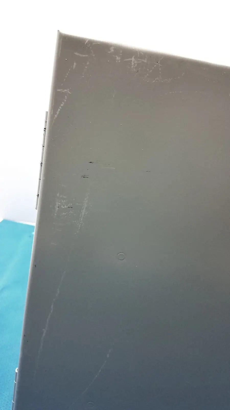 Gray metal box with scratches and a circular indentation on the back side of kryptonite cmt22a access control system