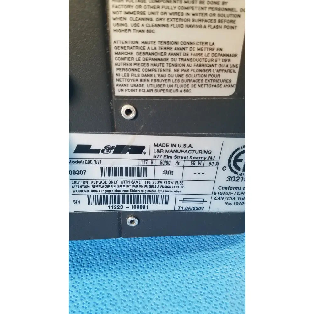 Black l&r model 090 electrical transformer with white label on back of quantrex q90 ultrasonic cleaner tabletop tank