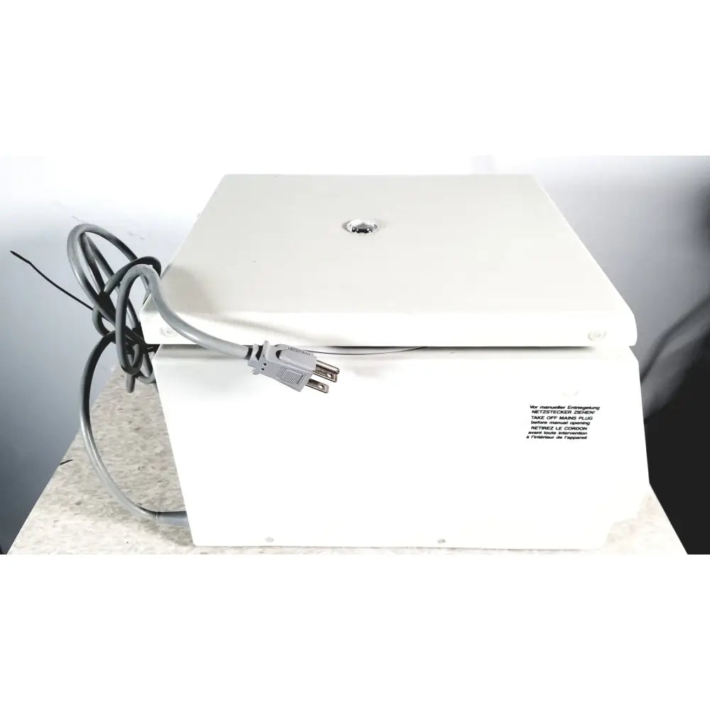 White rectangular electric labnet hermle centrifuge with gray power cord and label we manufacture entering for reuse medical