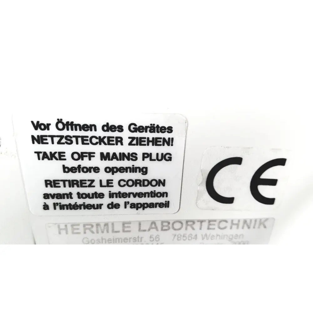 White rectangular label with black multilingual text and ce mark on back of labnet hermle z 200 a centrifuge for reuse medical safety certification