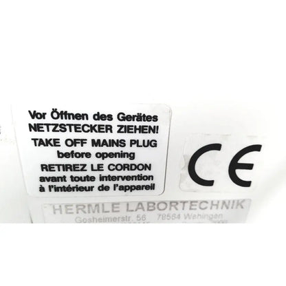 White rectangular label with black multilingual text and ce mark on back of labnet hermle z 200 a centrifuge for reuse medical safety certification