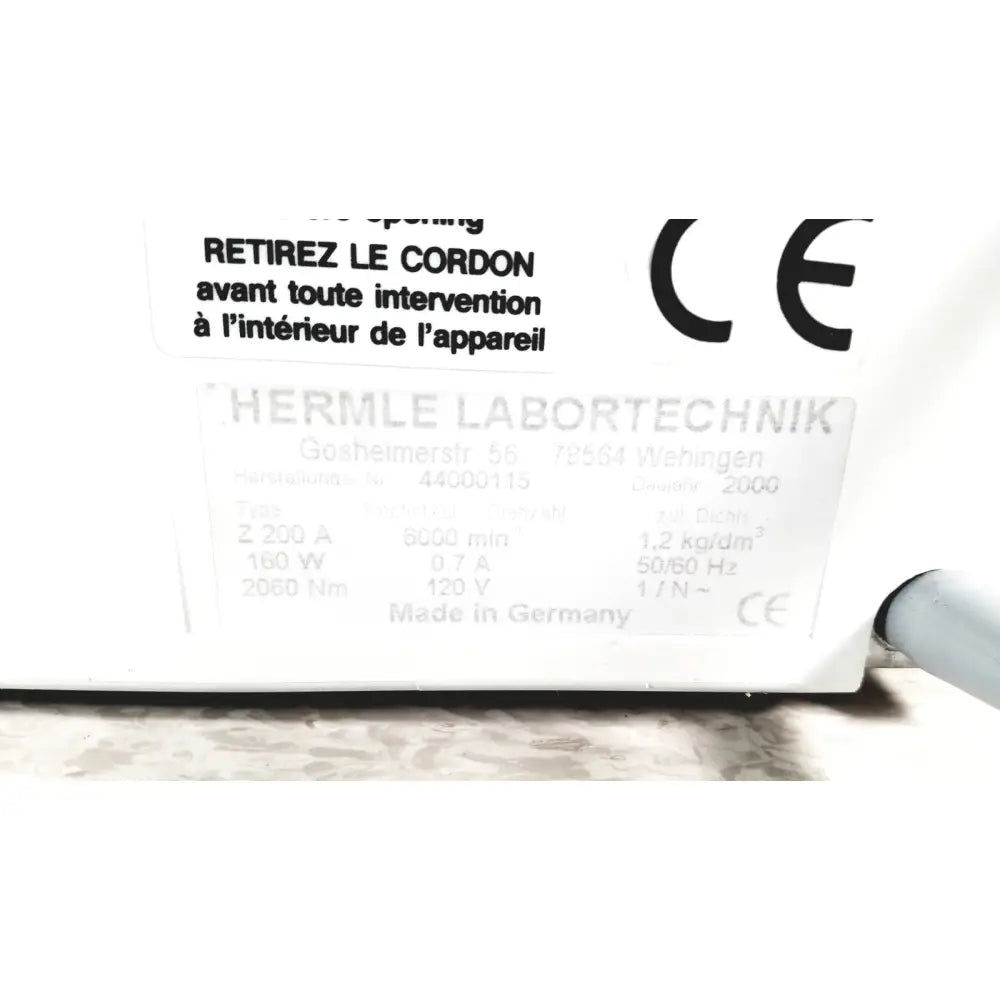 White rectangular label with ce marking and technical specifications on the back of labnet hermle z 200 a centrifuge for reuse medical applications