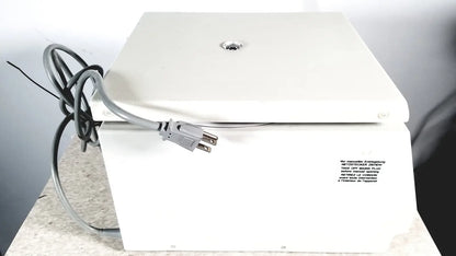 White rectangular electric labnet hermle centrifuge with gray power cord and label we manufacture entering for reuse medical