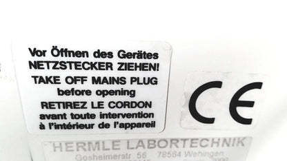 White rectangular label with black multilingual text and ce mark on back of labnet hermle z 200 a centrifuge for reuse medical safety certification
