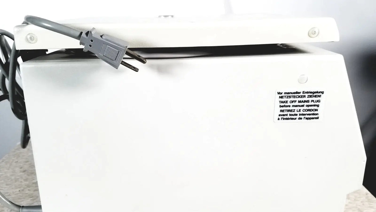White plastic labnet hermle z 200 a centrifuge back with gray power cord and multilingual safety instructions for reuse medical use