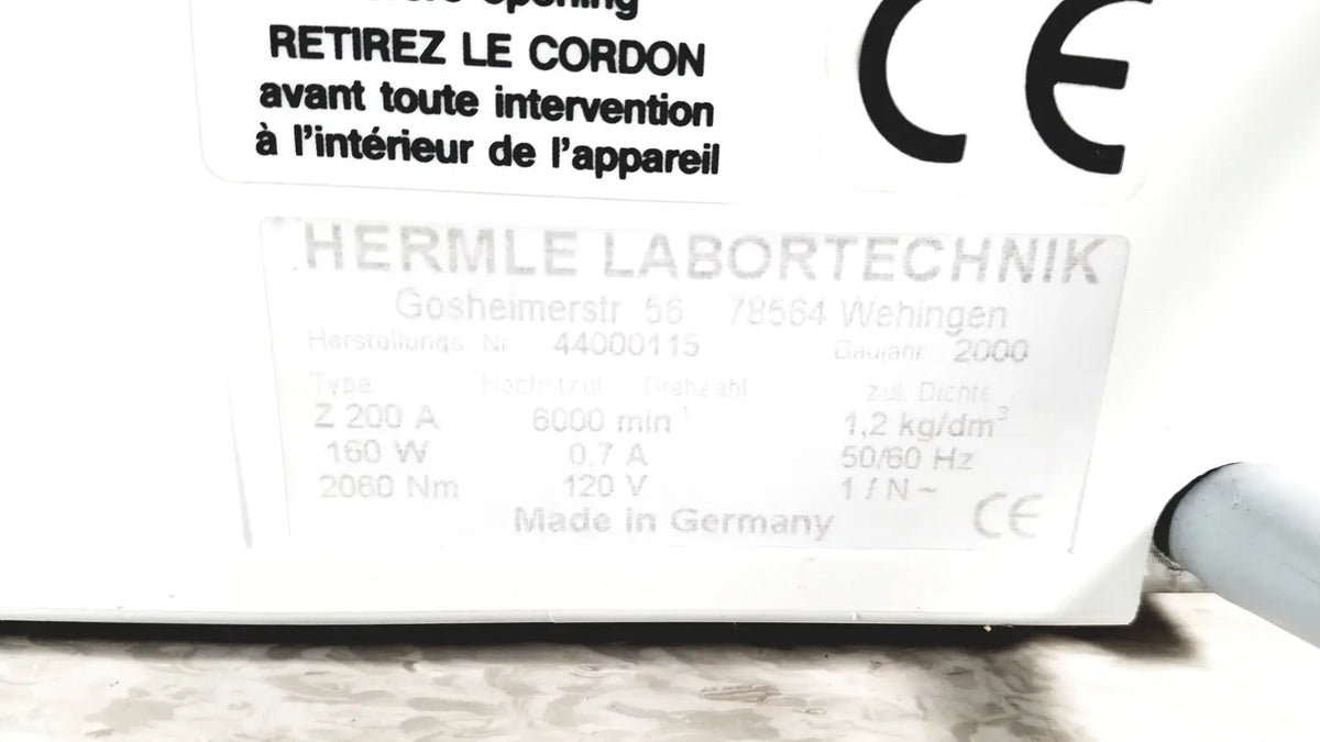 White rectangular label with ce marking and technical specifications on the back of labnet hermle z 200 a centrifuge for reuse medical applications