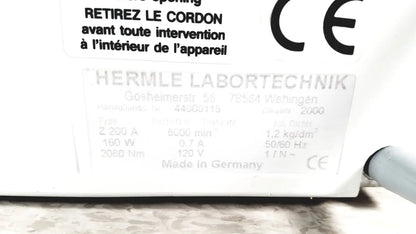 White rectangular label with ce marking and technical specifications on the back of labnet hermle z 200 a centrifuge for reuse medical applications