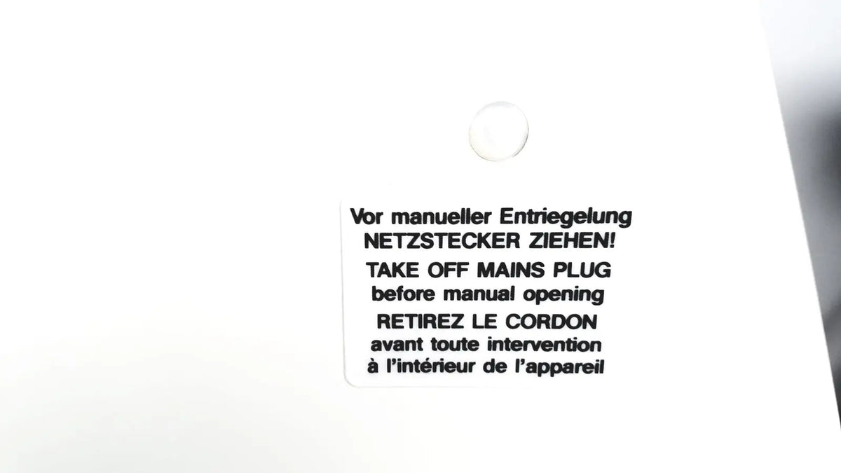 White rectangular label with black text in three languages instructing mains plug removal before manual opening on labnet hermle z 200 a centrifuge back side for reuse medical equipment