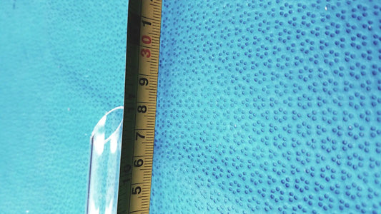 A translucent blue textured glass thermometer joint adapter with raised dots for laboratory glassware thermometer use