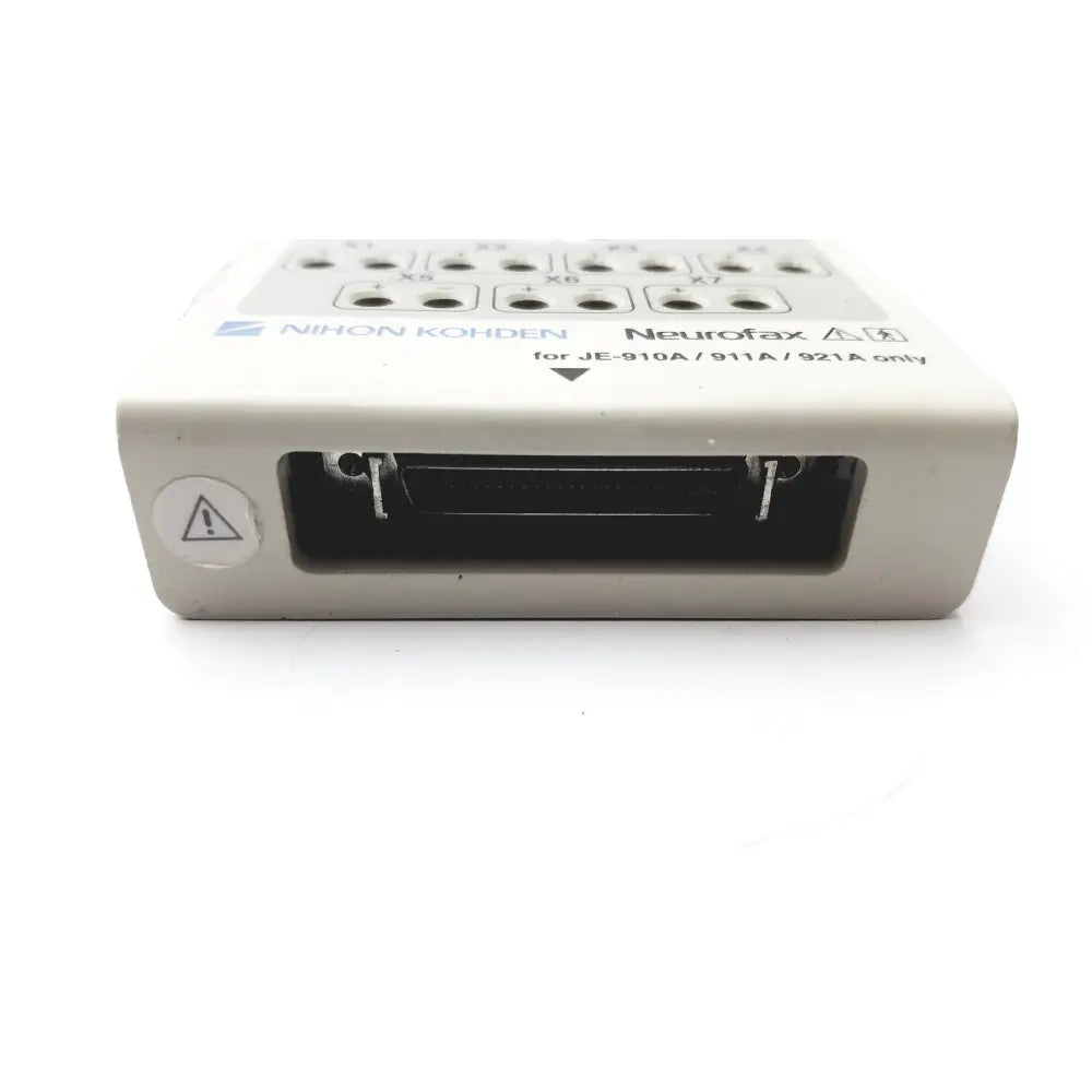 Beige laerdal compact suction unit 4 with labeled input ports and warning symbol on the back side of the device