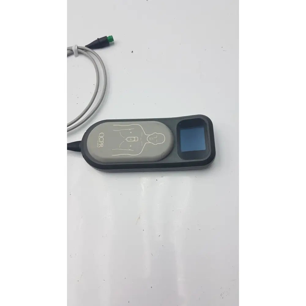 Gray and black laerdal cpr meter with small screen diagram of chest compression points and attached cables for cpr use