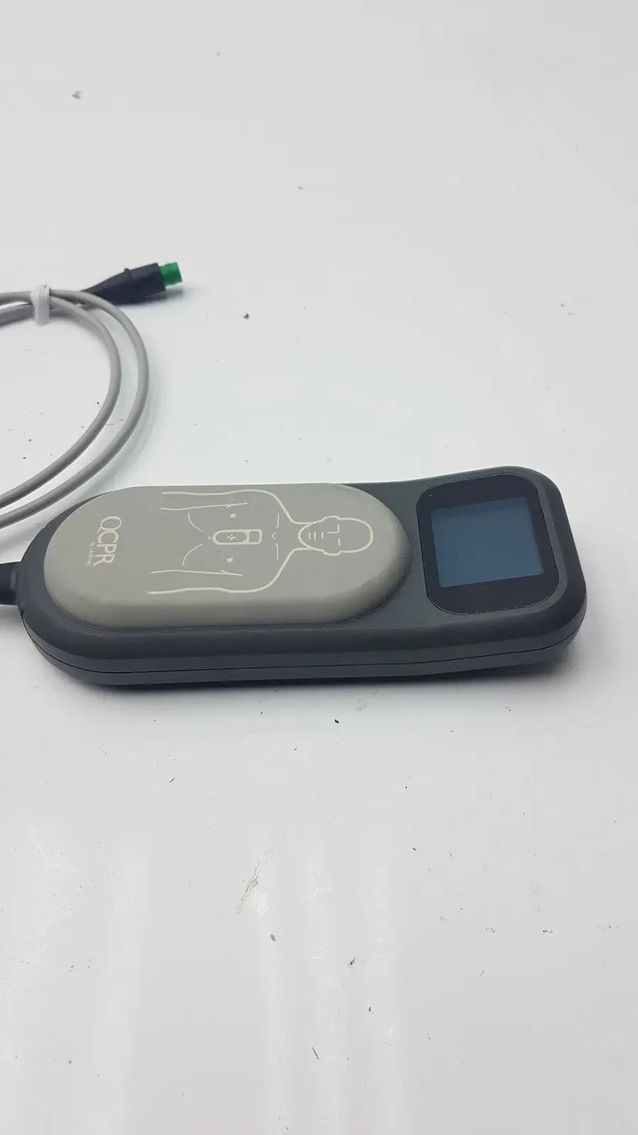 Black and gray laerdal cpr meter 453564257691 with small screen, chest compression diagram, and connected cables