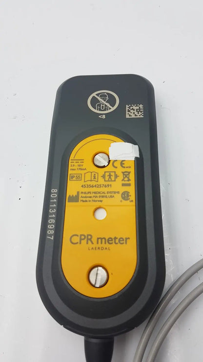 Black and yellow laerdal cpr meter with rounded rectangular design and philips label model 45356-4257691 visible