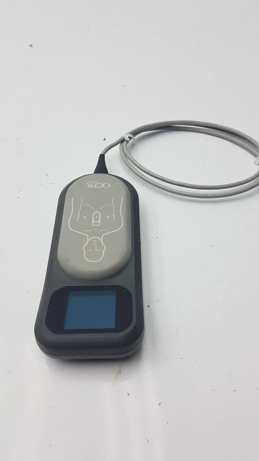 Gray and black Laerdal CPR meter 453564257691 with screen electrode pad diagram and attached cable for automated external defibrillator use