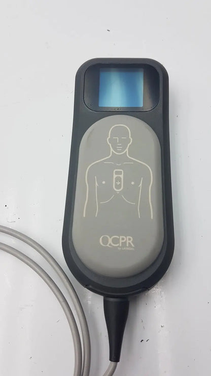 Gray and black laerdal cpr meter 453564257691 with small screen human silhouette and connected electrode cable for cpr