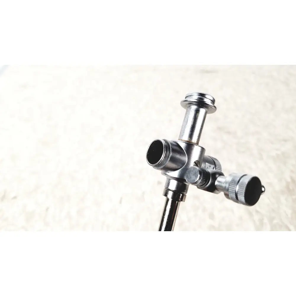 Silver metallic laparoscopic obturator tripod head with central column and adjustable arms for reuse medical laparoscopic instruments