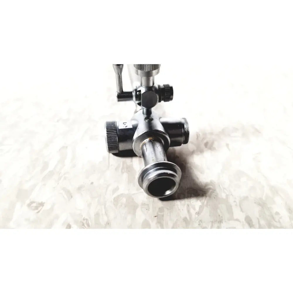 Black metal gas regulator with threaded ports and knurled knobs for laparoscopic obturator and reuse medical instruments